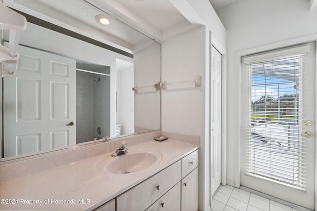 bathroom featuring tile patterned flooring, vanity, and toilet