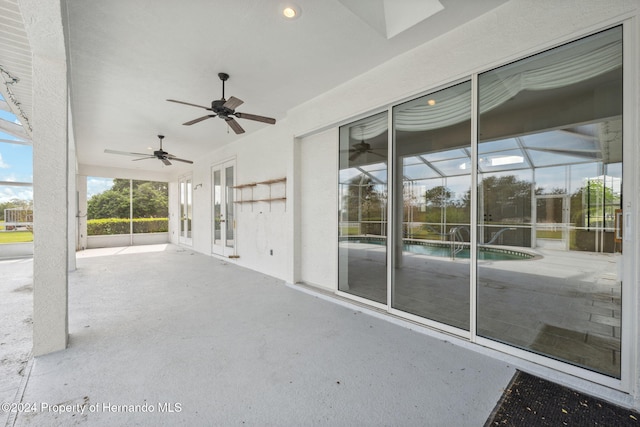 view of patio / terrace featuring ceiling fan and a lanai