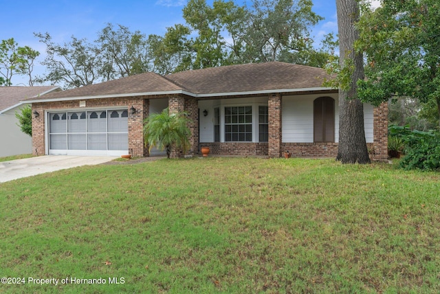 ranch-style home featuring a front yard, a porch, and a garage