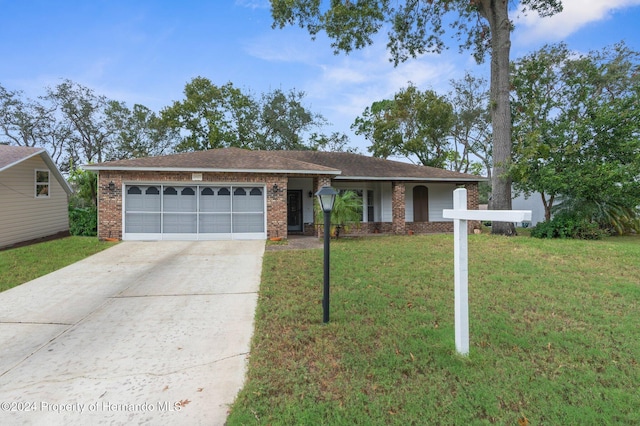 single story home featuring a front lawn and a garage