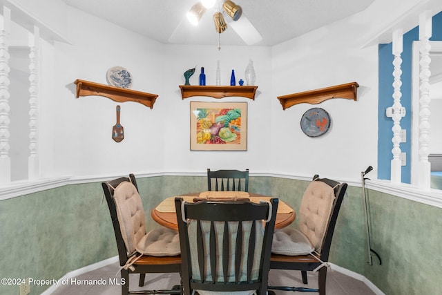 tiled dining space with ceiling fan