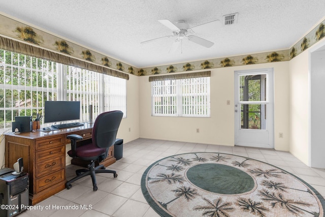 office area with ceiling fan, light tile patterned flooring, and a textured ceiling