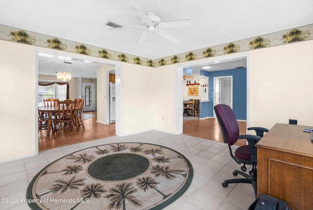 office area featuring ceiling fan with notable chandelier and light hardwood / wood-style floors