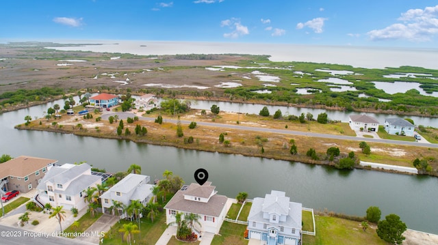 drone / aerial view featuring a water view and a residential view