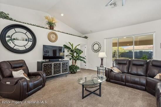 carpeted living room with lofted ceiling