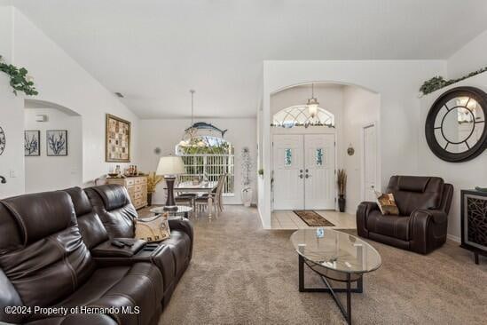 living room with carpet flooring and vaulted ceiling