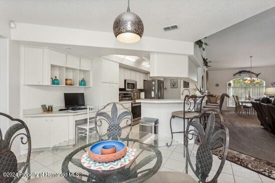 tiled dining space featuring lofted ceiling