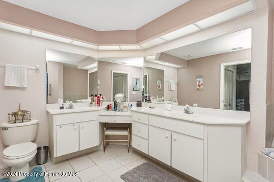 bathroom featuring tile patterned flooring, vanity, and a bathtub