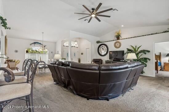 living room with ceiling fan, carpet, and lofted ceiling