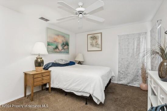 bedroom featuring dark carpet and ceiling fan