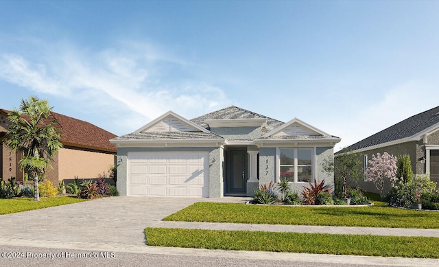 view of front of house featuring a front lawn and a garage