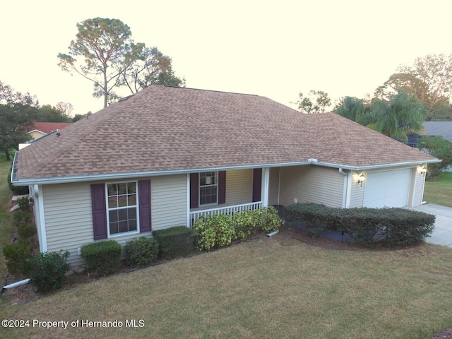 single story home with a garage and a front yard