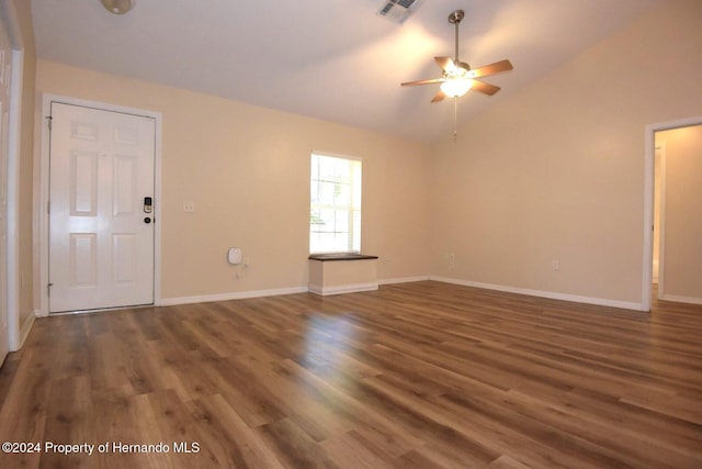 unfurnished living room featuring ceiling fan, dark hardwood / wood-style flooring, and vaulted ceiling