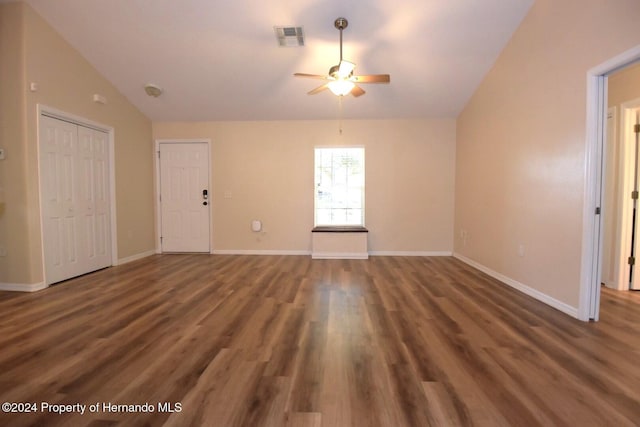 spare room with ceiling fan, dark hardwood / wood-style flooring, and vaulted ceiling