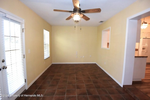 unfurnished room with ceiling fan