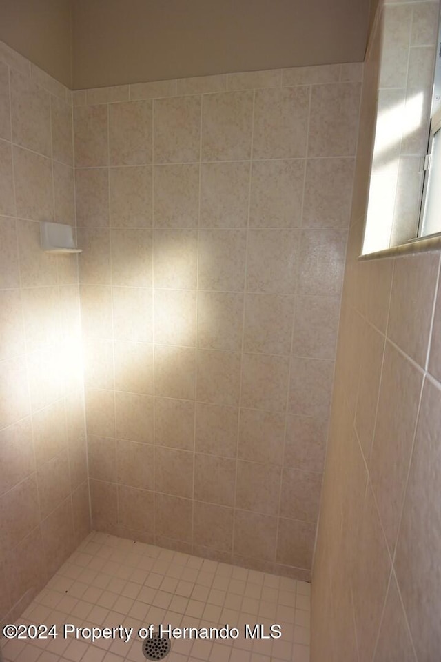 bathroom with a tile shower