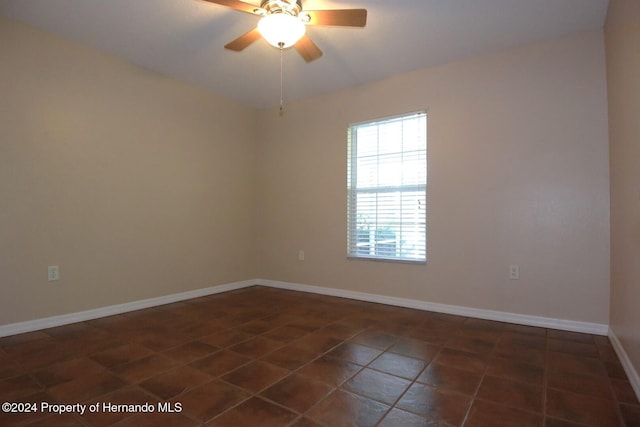 tiled empty room with ceiling fan