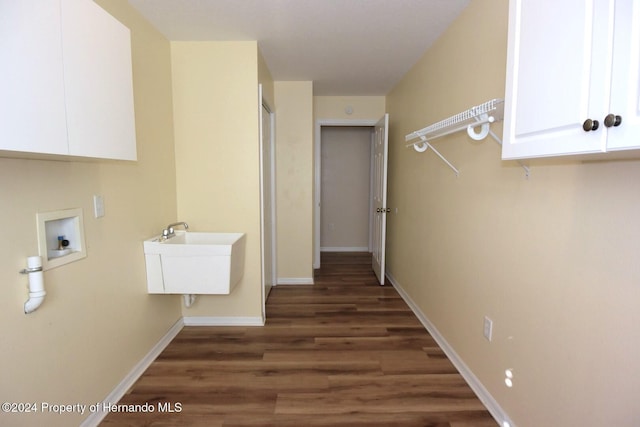 clothes washing area featuring sink, cabinets, dark wood-type flooring, and hookup for a washing machine