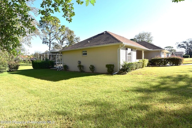 view of home's exterior featuring a lawn and a lanai