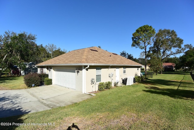 view of property exterior featuring a lawn and a garage