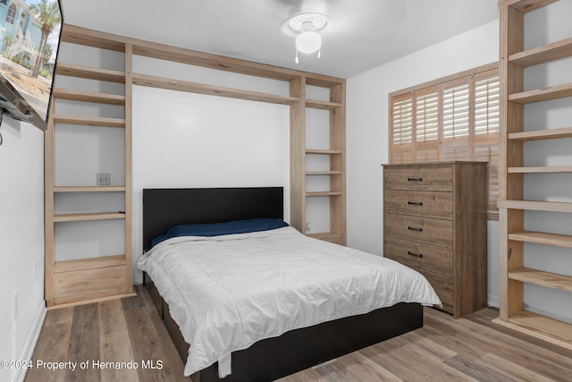 bedroom with ceiling fan and wood-type flooring