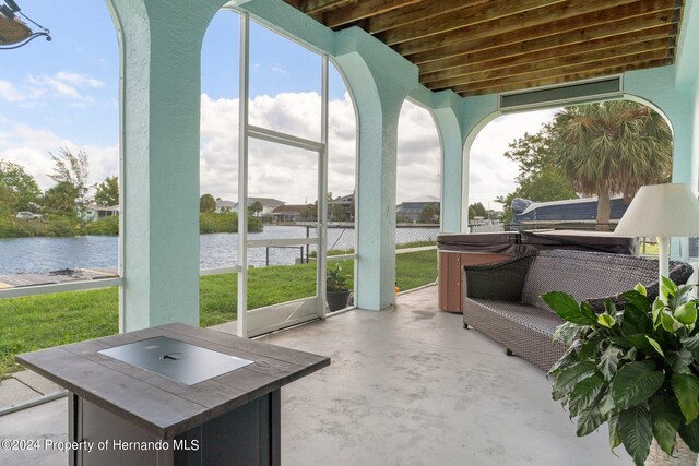 unfurnished sunroom with a water view