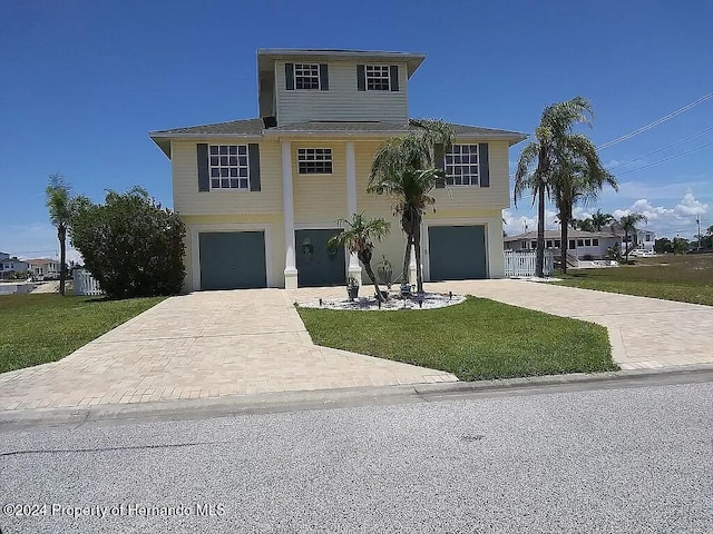 view of front of home featuring a garage and a front lawn