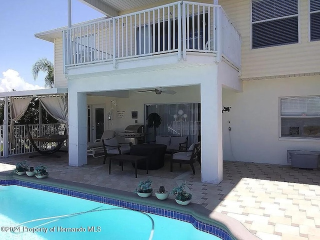 back of property with ceiling fan, a balcony, and a patio area