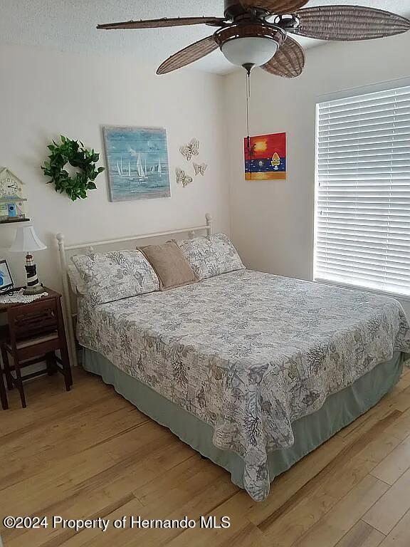 bedroom featuring hardwood / wood-style flooring and ceiling fan