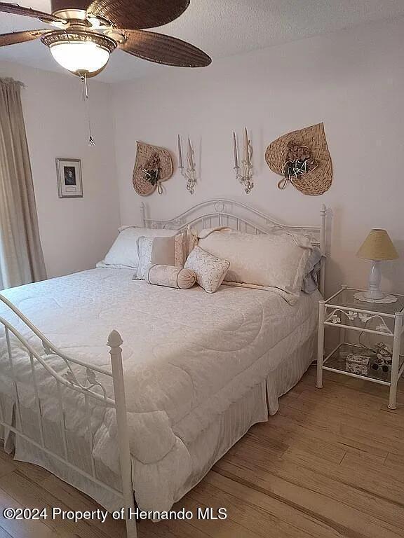 bedroom featuring hardwood / wood-style floors and ceiling fan