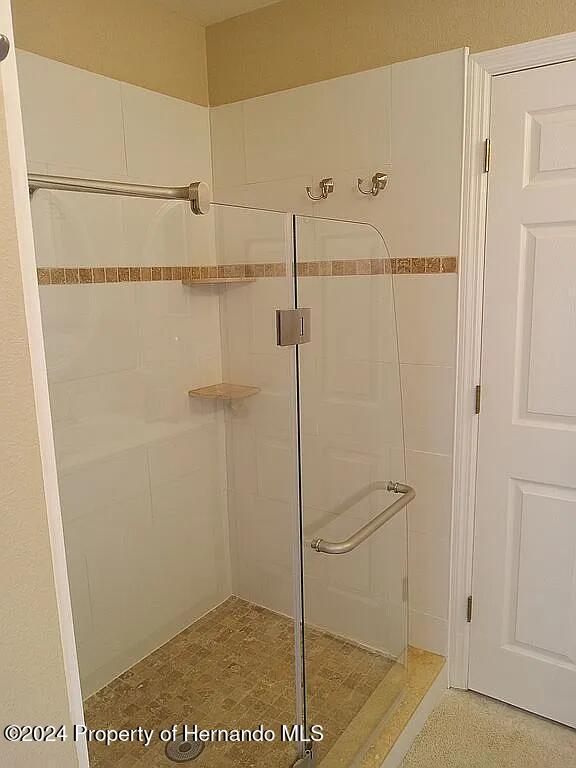 bathroom with a shower with shower door