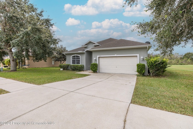 ranch-style house featuring a garage and a front lawn