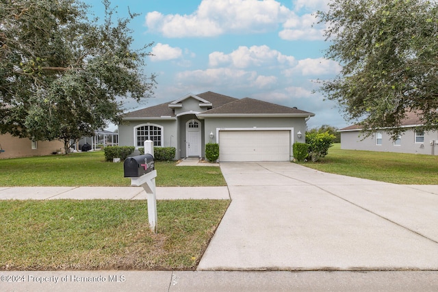 ranch-style home with a front yard and a garage