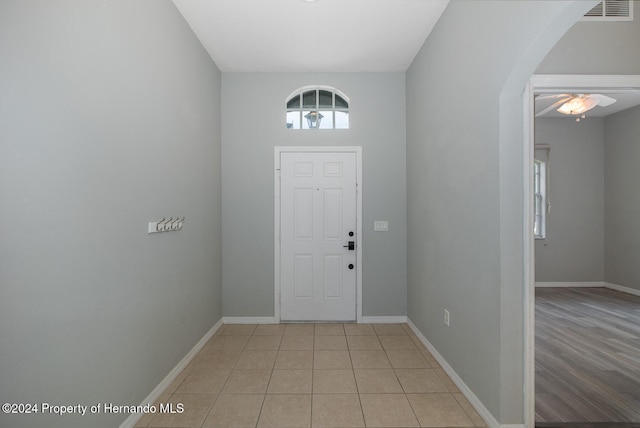 entrance foyer with ceiling fan and light wood-type flooring