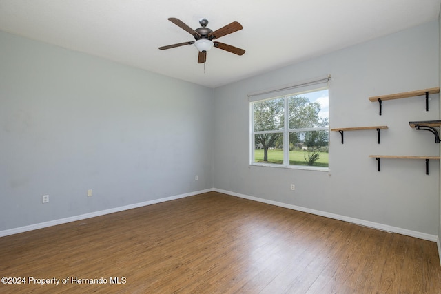 empty room with hardwood / wood-style floors and ceiling fan