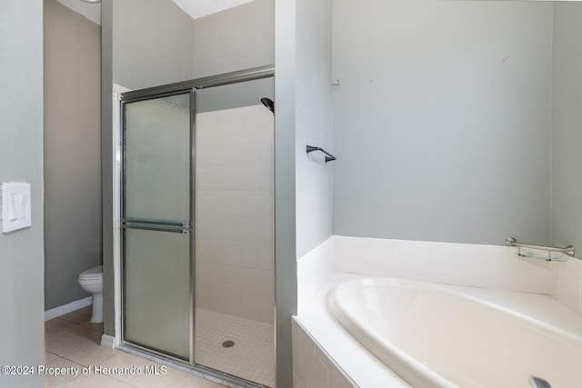 bathroom featuring toilet, independent shower and bath, and tile patterned flooring