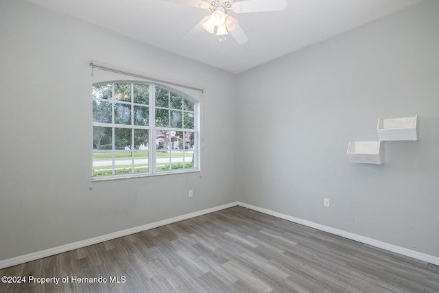 empty room with ceiling fan and light wood-type flooring