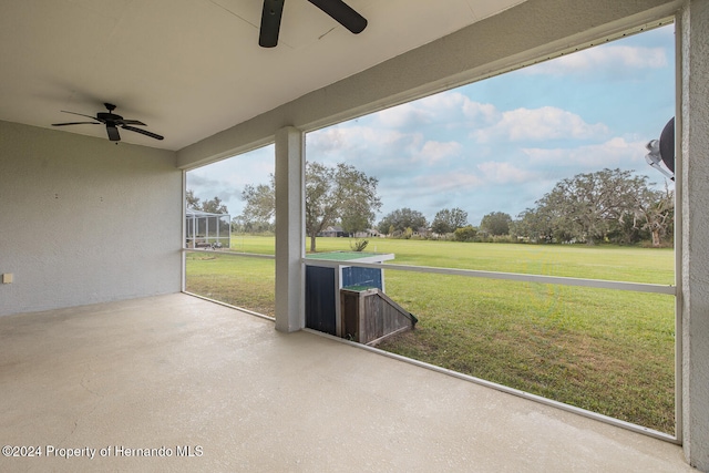 unfurnished sunroom with ceiling fan