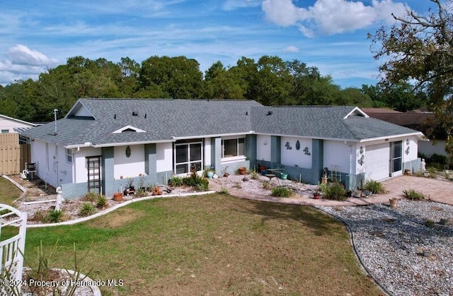 single story home featuring a garage and a front lawn