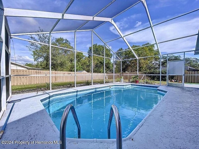 view of pool featuring a patio area and a lanai