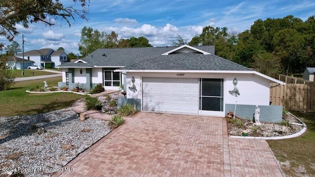 back of house featuring a garage and a lawn