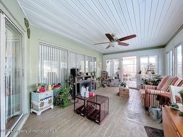 sunroom featuring ceiling fan and wooden ceiling