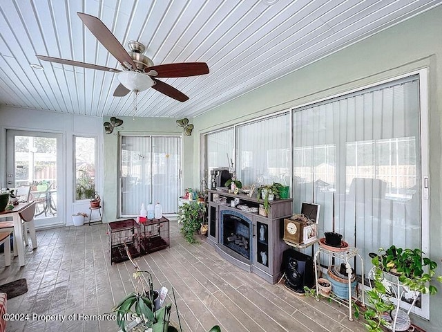 sunroom with ceiling fan and wood ceiling