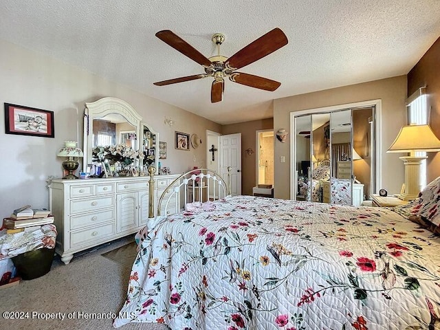 bedroom featuring ceiling fan, a textured ceiling, carpet, multiple windows, and a closet