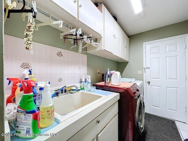 laundry room featuring tile walls, a textured ceiling, cabinets, sink, and tile patterned flooring