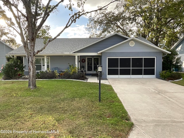 view of front of property with a front lawn and a garage