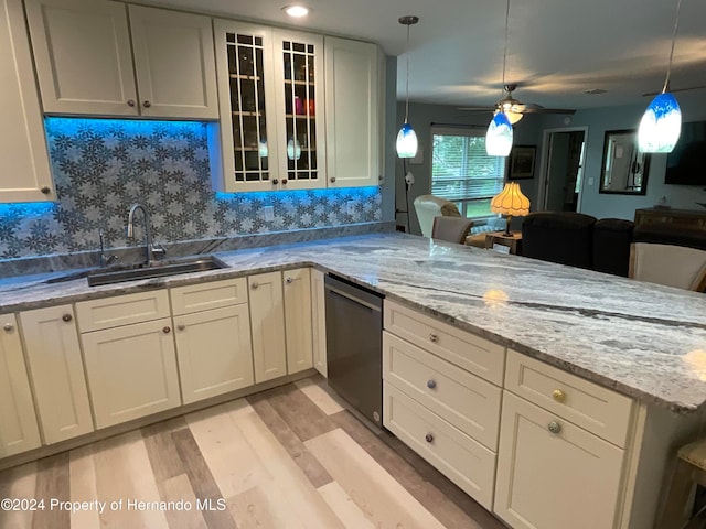 kitchen featuring light hardwood / wood-style floors, dishwasher, sink, tasteful backsplash, and ceiling fan