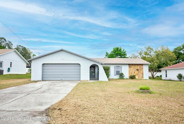 ranch-style home featuring a garage and a front lawn