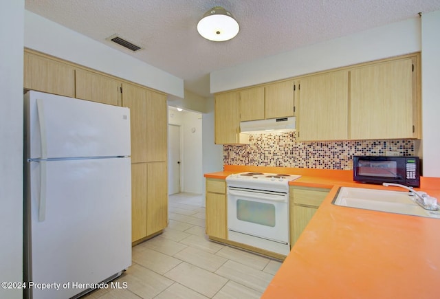 kitchen featuring a textured ceiling, decorative backsplash, white appliances, and sink