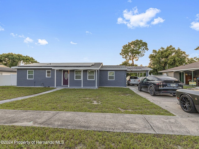 1009 Cobbelstone Dr, Spring Hill, FL 34606 - ranch-style home with roof mounted solar panels and driveway